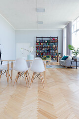 The interior design of the studio apartment in Scandinavian style. A spacious huge room in light colors. stylish expensive luxury furniture.