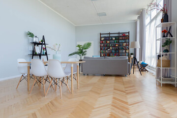 The interior design of the studio apartment in Scandinavian style. A spacious huge room in light colors. stylish expensive luxury furniture.