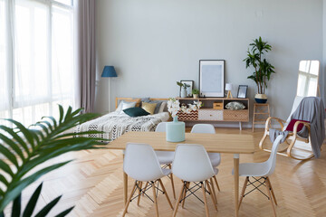 The interior design of the studio apartment in Scandinavian style. A spacious huge room in light colors. stylish expensive luxury furniture.