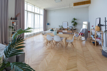 The interior design of the studio apartment in Scandinavian style. A spacious huge room in light colors. stylish expensive luxury furniture.