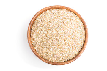 Wooden bowl with raw white quinoa seeds isolated on white background. Top view.