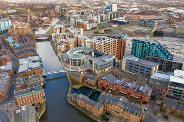 Obraz premium Aerial photo of the area in the Leeds City Centre known as Brewery Wharf on a beautiful sunny summers day showing buildings by the Leeds and Liverpool canal with building on the canal bank