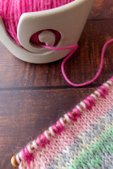 knitting background with yarn bowl and pink fair isle project 