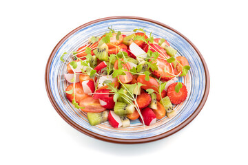 Vegetarian fruits and vegetables salad of strawberry, kiwi, tomatoes, microgreen sprouts isolated on white background. Side view.