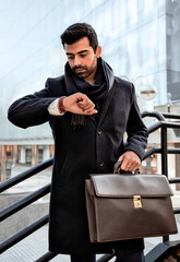 Fototapeta premium Businessman looking at the time to go to work