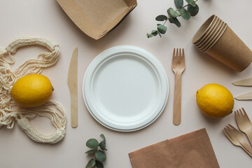 Eco-friendly disposable organic utensil. Knives, forks, empty plate, string bag and paper bag and...