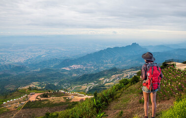 Fototapeta na wymiar Tourist girl with backpack on high mountain viewpoint
