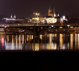 Fototapeta na wymiar .panoramic view of Prague Castle and St. Vitus Cathedral and the Vltava River and street lights on bridges at night in the center of Prague