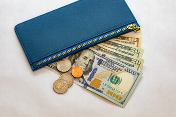 Woman getting money out of her blue wallet