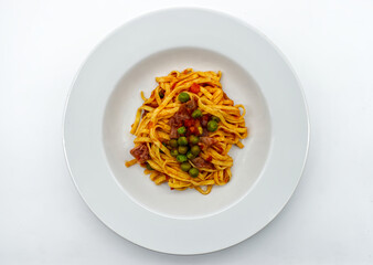 Fresh italian Tagliatelle with ham and peas sauce. Traditional Italian pasta.  Top view