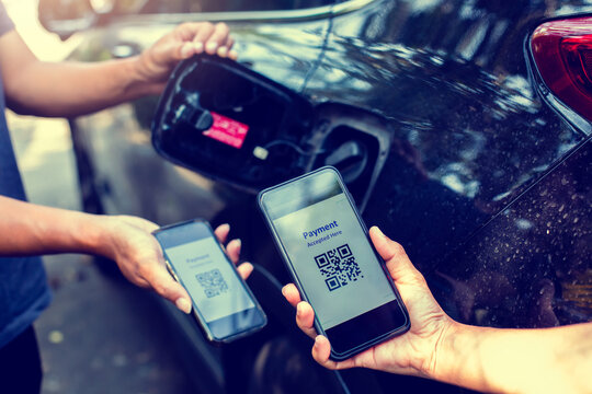 Selective Focus To Hand Using Smart Phone To Scan QR Code Tag With Blurry Fuel Tank Cap After Refueling Is Complete. The Customer Is Paying For The Car Fuel With QR Code.