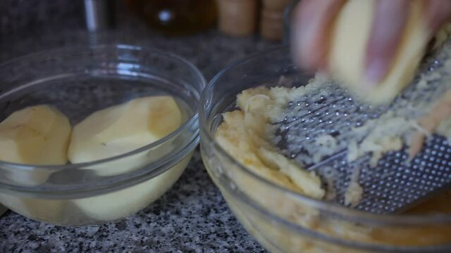 Closeup of Cooking otato pancakes draniki on grater . High quality FullHD footage