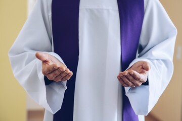 Catholic priest hands in praying or blessing gesture - obrazy, fototapety, plakaty