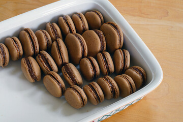Homemade Chocolate cocoa macaron cookies filled with chocolate hazelnut spread