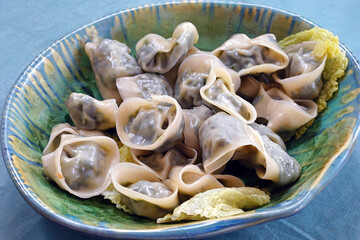 Platter of steamed  Chinese dumplings with spinach filling