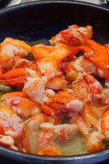 Sauteeing lobster meat in a pan