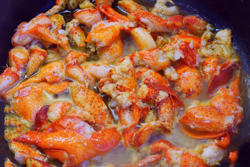 Sauteeing lobster meat in a pan