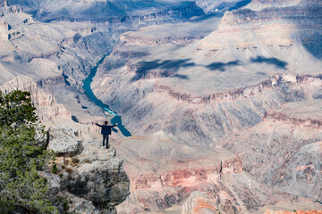 A Man Standing on the Rim of the Grand Canyon
