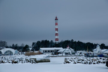 View of the Osinovetsky lighthouse on a cloudy winter day. Frozen Ladoga Lake.