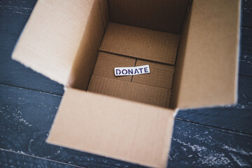 charity donation and decluttering, empty box with Donate label ready to be filled with second-hand items