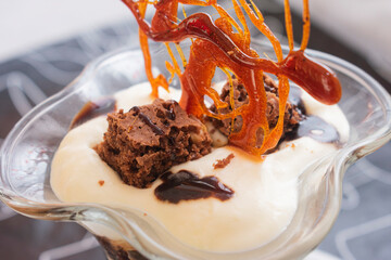 Pieces of chocolate brownie cake with whipped cream and caramel