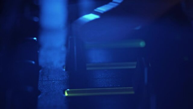 Professional DJ Plays a Beat Sampler with Color Drum Pads and Samples in Studio Environment. Beatmaker Plays edm Tracks on Party in a Nightclub. Electronic Musical Instrument. Unrecognizable person