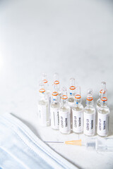 Group of COVID-19 vaccine bottles, vials, selective focus.