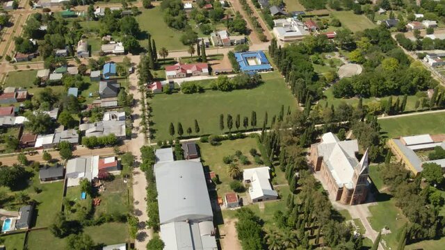 Aerial tilt up revealing romantic style church, Santa Anita town and beautiful Entre Rios countryside, Argentina