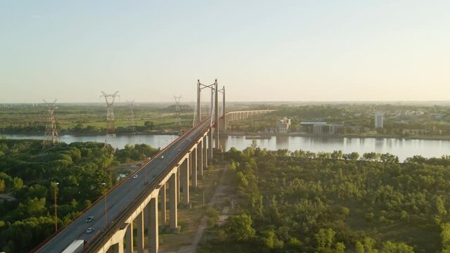 Orbital of Zarate Brazo Largo road and railway complex cable-stayed bridge crossing Parana river connecting Buenos Aires and Entre Rios at golden hour, Argentina