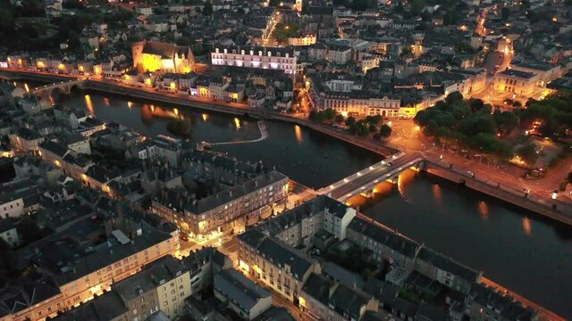 Evening aerial view of Laval with buildings, river Mayenne and old bridge, Mayenne department, north-western France. High quality 4k footage