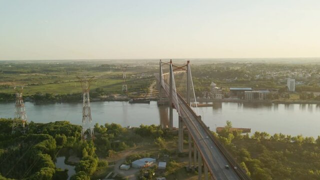 Pan left of Zarate Brazo Largo road and railway complex cable stayed bridge crossing Parana river and connecting Buenos Aires y Entre Rios at sunset, Argentina