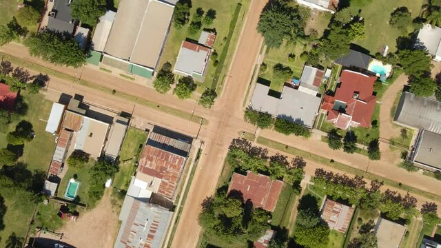 Orbital top down lowering over Santa Anita countryside town houses, trees and swimming pools, Entre Rios, Argentina