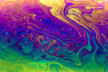 Fototapeta na wymiar Close up macro, detailed shot of a soap bubble in professional, studio setting with black background behind. Stunning rainbow, colors with purple, green, yellow, green blue stunning, pretty beautiful