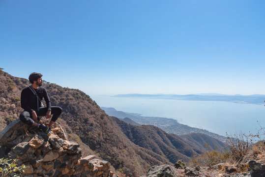 hiker at the top of mountain of Lake Chapala and its city in Ajijic Mexico