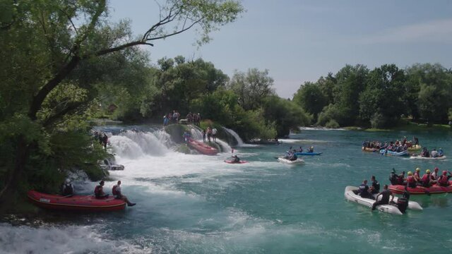 Aerial view on large number of young people enjoying slow rafting on river Una in Bosnia.