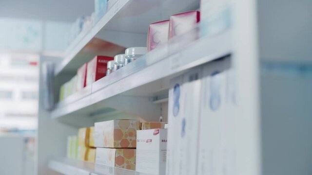 Modern Pharmacy Drugstore with Shelves full of Packages with Modern Medicine, Pill Drugs, Boxes with Vitamins and Supplements, Health Care and Beauty Products. Moving Backward Close-up Camera Shot