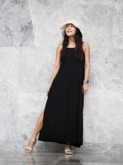 Fototapeta premium portrait of young asian woman in black dress and white hat