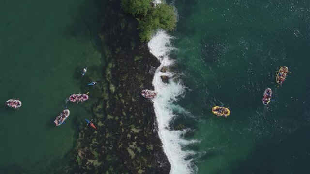 Aerial view on large number of young people enjoying slow rafting on river Una in Bosnia.