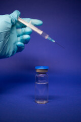 Development of coronavirus vaccine COVID-19. medical syringe with injection needle in blue medical...