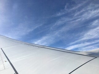 Fototapeta na wymiar Aircraft wing in the sky