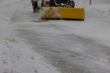 Tractor clears the snow removal vehicle removing snow way after heavy snowfall