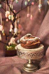 Traditional cupcake Easter cake kraffin craffin with raisins on dark purple background. homemade cake Cruffin with dried fruits. Easter decoration table. easter desert celebration. Layers of the cake