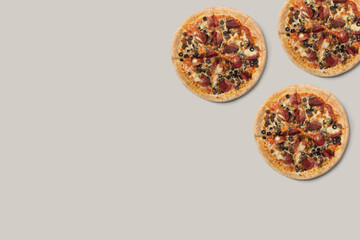 The pizzas are delicious and the ingredients are sausage, bacon and mozzarella on a brown background. can be made of backgrounds, flyers and other forms of advertising,