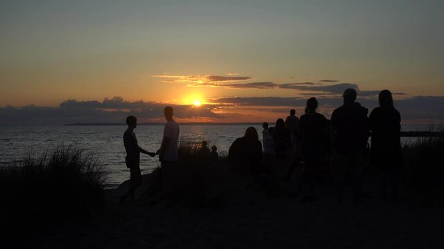 a group of people watching the sunset
