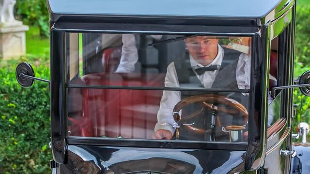 Chauffeur Reversing Vintage Bridal Car. Follow Shot