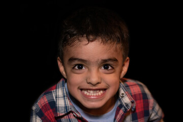 smiling adorable child with black background