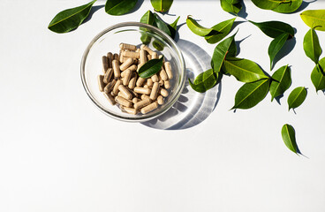 Vitamin capsules in a glass cup. Trace elements and health supplements. Glass shadow and fresh...