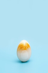 Yellow stone texture Easter egg. Minimal style composition, Spring celebration concept.