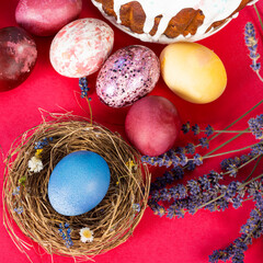 Colorful background with Easter eggs on red- background. Happy Easter concept. Can be used as poster, background, holiday card. Flat lay, top view, copy space. Studio Photo