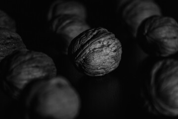 black and white photo of several walnuts placed on a table